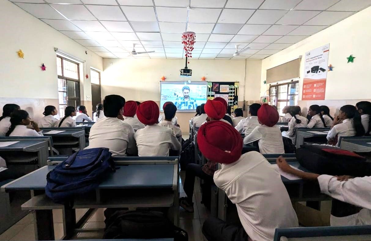 Students watching a documentary film in class