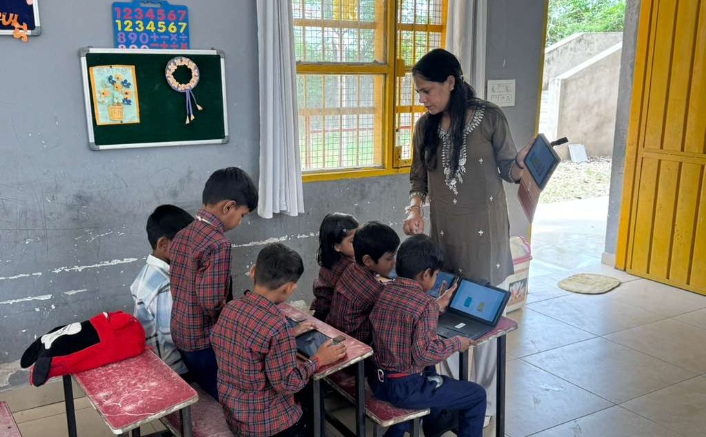 A teacher guiding students using tablets in the classroom